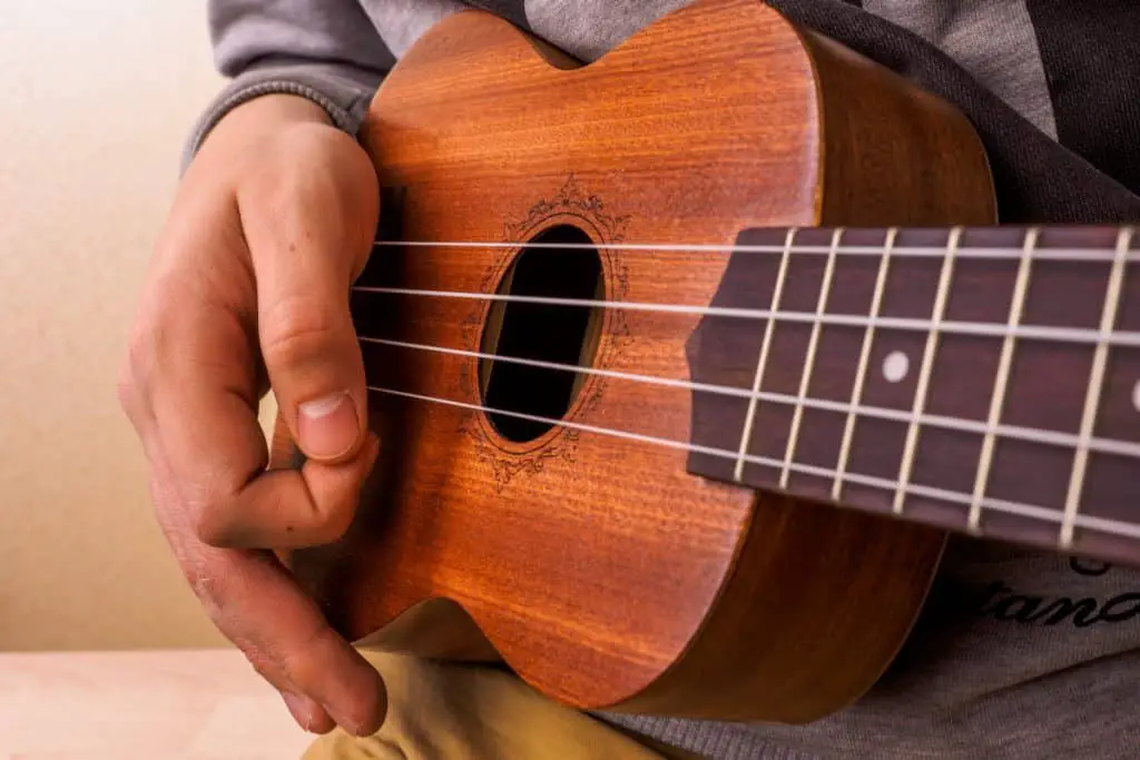 close up of fingers on a uke