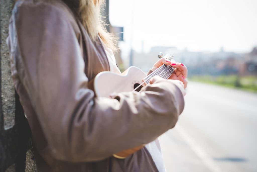 woman playing concert uke