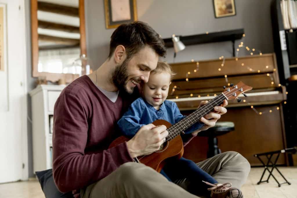 dad teaching son ukulele