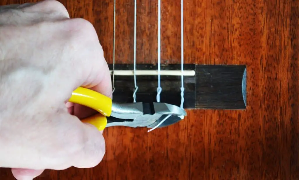 Step 9: to finish off and to make the knot look a bit bit neater, snip off the end with a pair guitar string pliers or wire clippers.  Scissors should also be fine for this job.